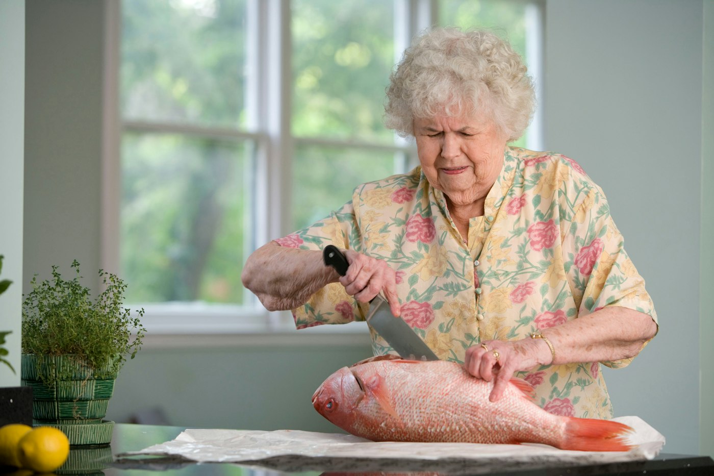 An older woman preparing fresh food