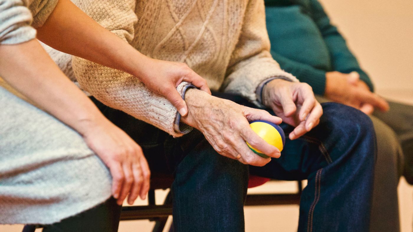 Hands holding a therapy ball